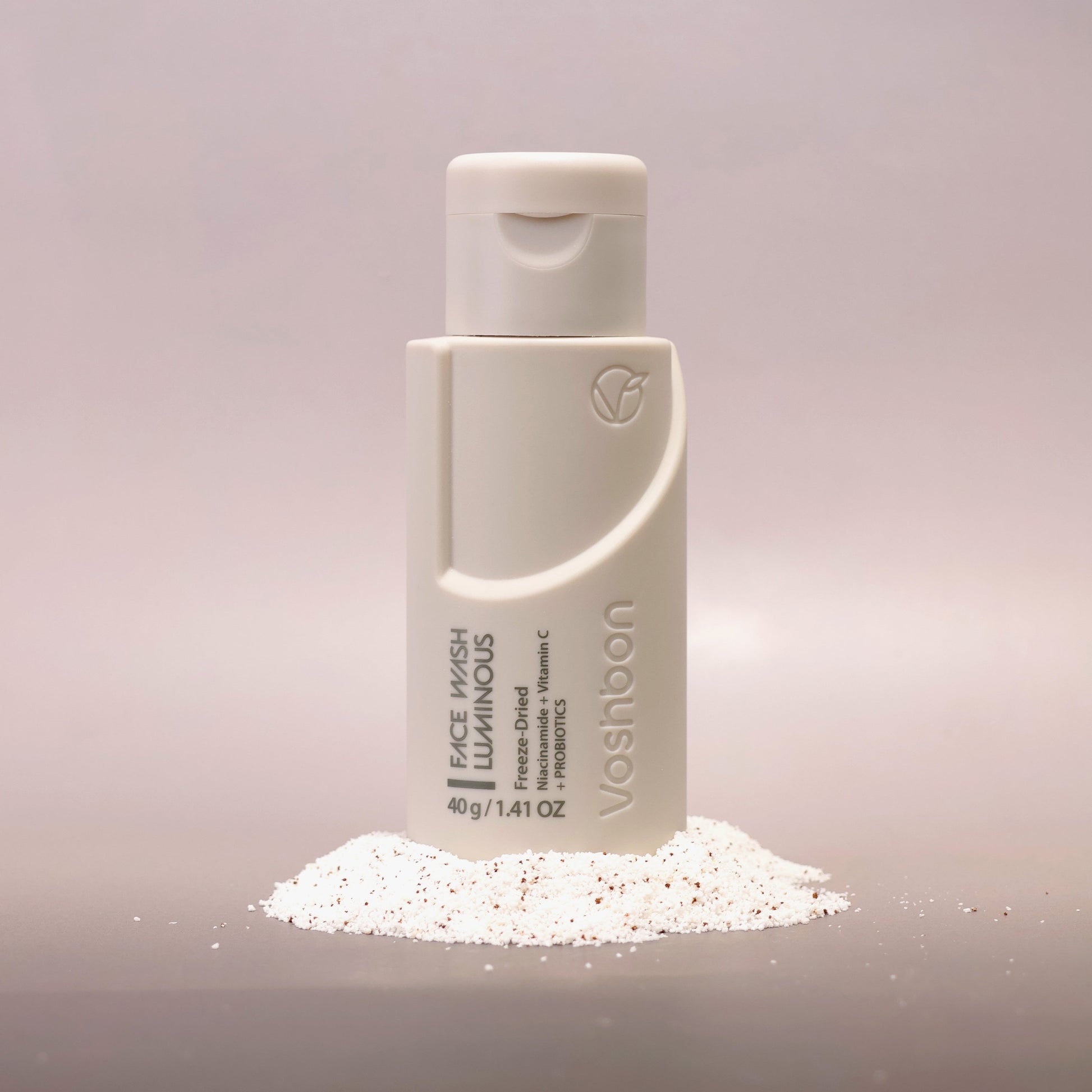 Voshbon Luminous Face Wash on Granules with a gradient gray background.